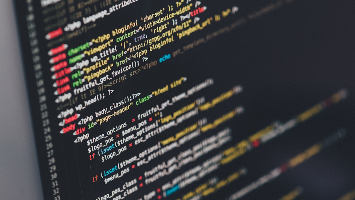 Software code on a monitor, topical technology image